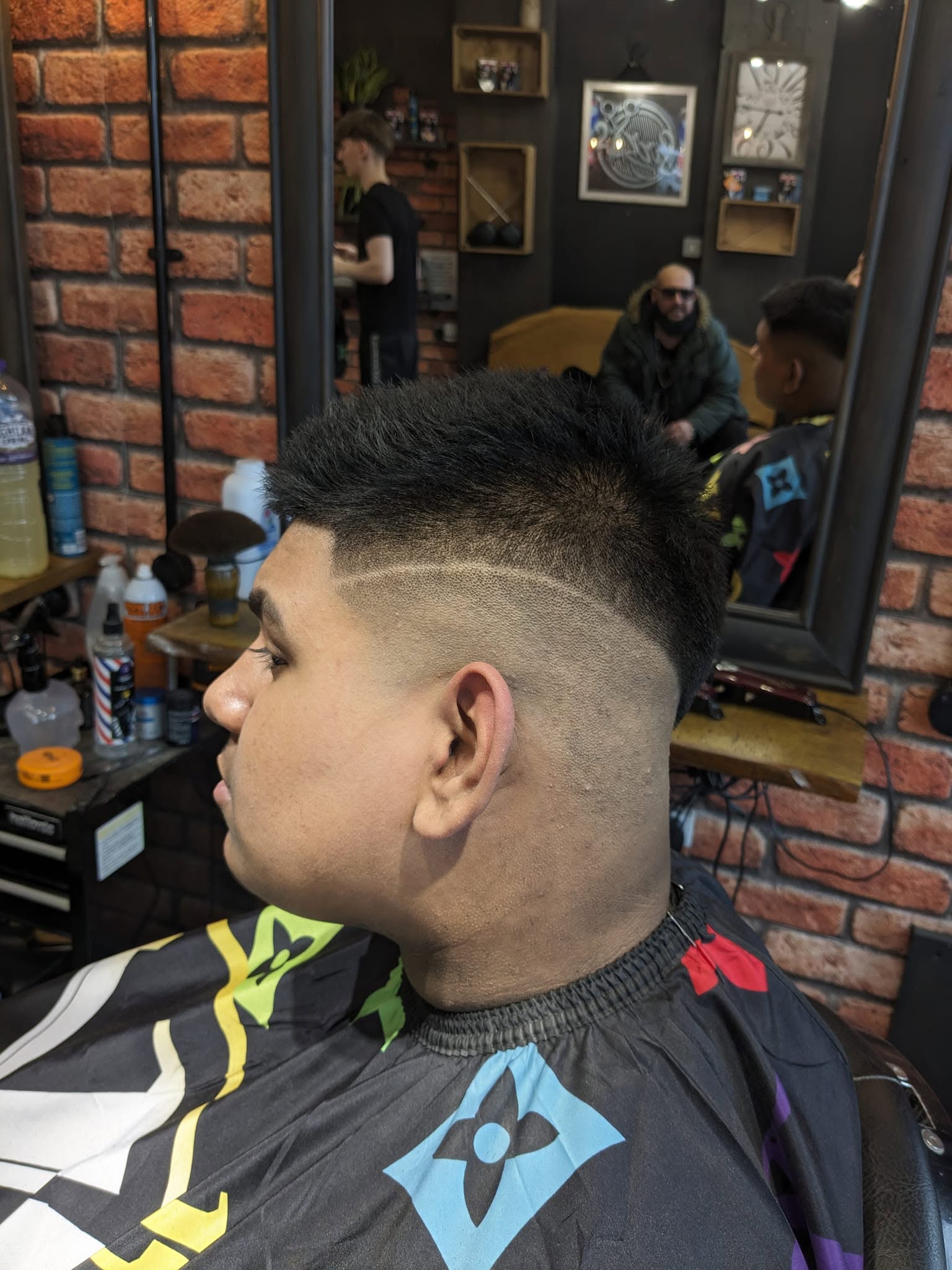 Curly top with a high bald fade