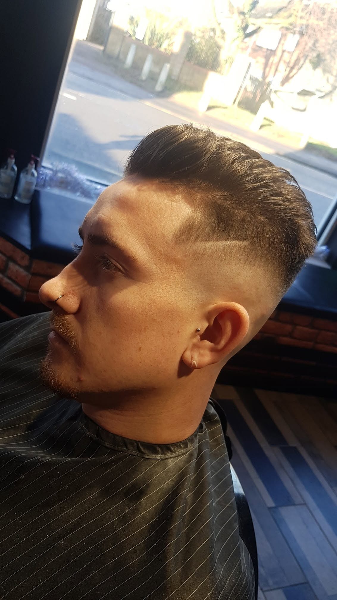High skin fade with a hard parting